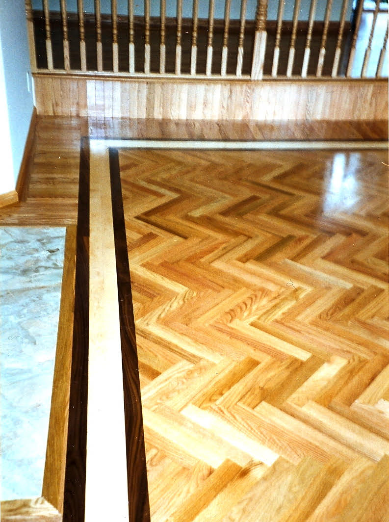 New hardwood floor installed in a Chevron pattern with walnut borders. San Francisco.